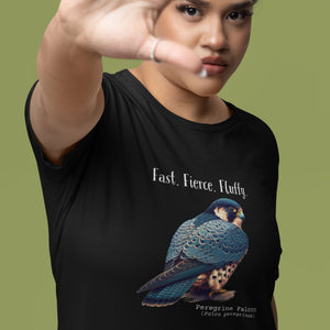 A black women's bird shirt with the words, "Fast. Fierce. Fluffy" above an illustration of a peregrine falcon. Worn by a woman.