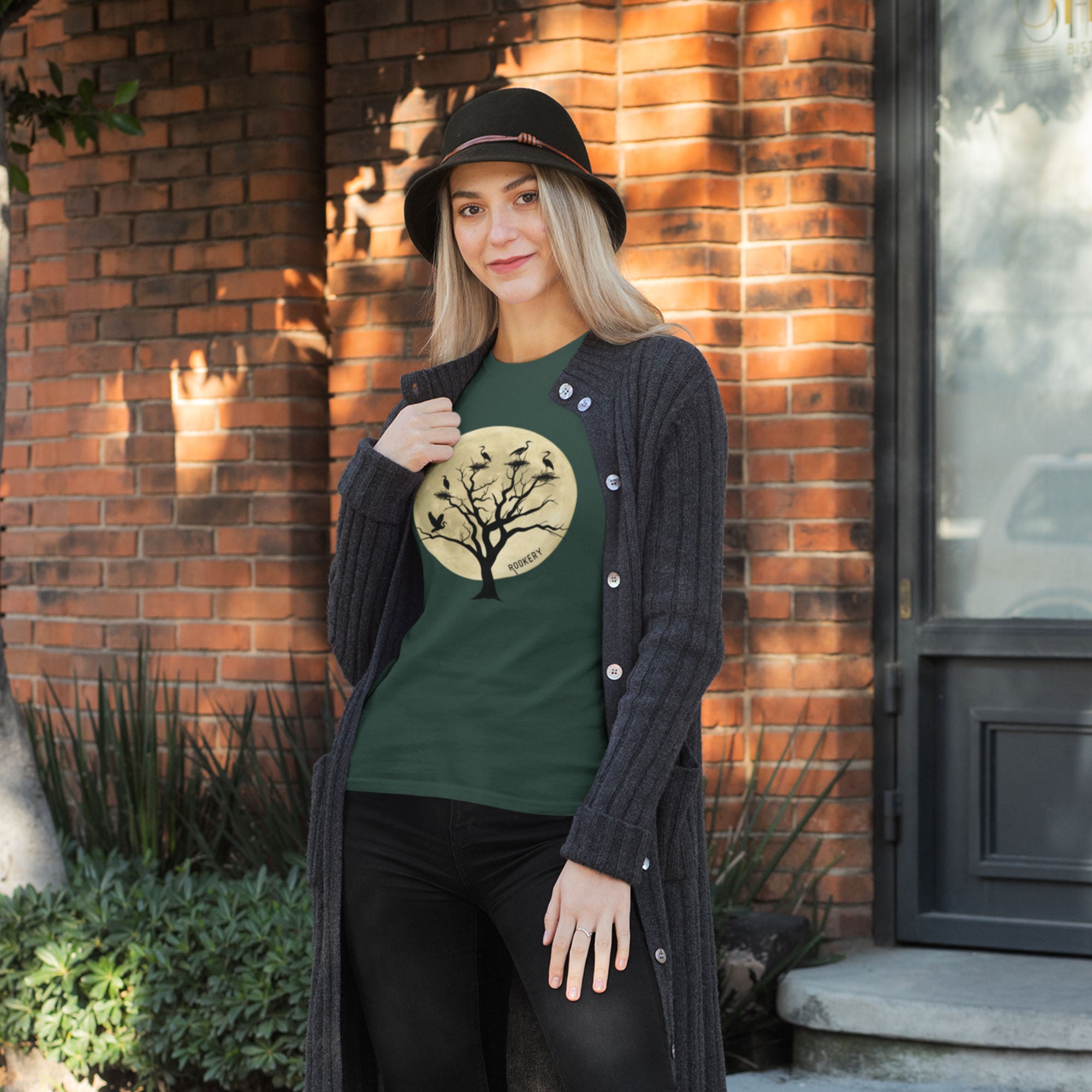 Green unisex bird shirt with a full moon outlining a heron rookery.  Worn by a woman.