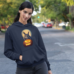 Navy Blue unisex hoodie with a picture of a great horned owl sitting on a carved pumpkin in front of a full moon on the front. Worn by a woman.