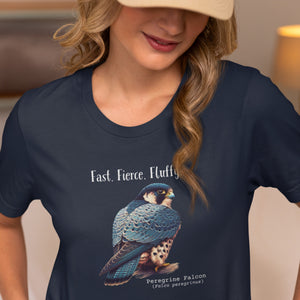 A navy blue bird shirt with the words, "Fast. Fierce. Fluffy" above an illustration of a peregrine falcon. Worn by a woman.