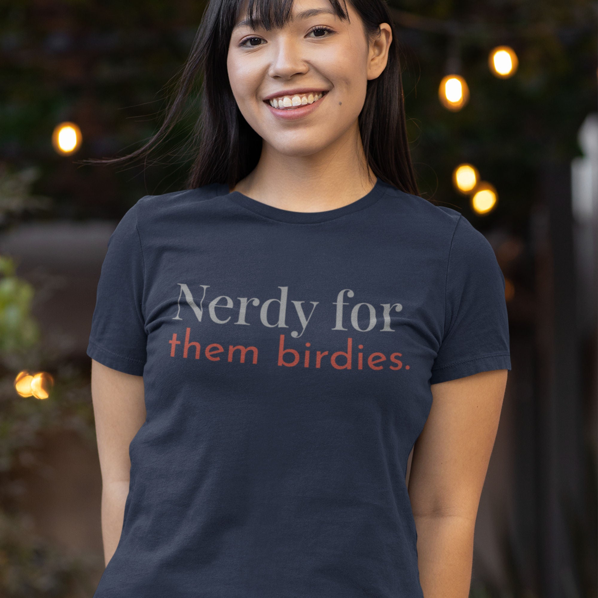 Black women's bird shirt with the words Nerdy for them birdies on the front in two coordinating fonts and colors.