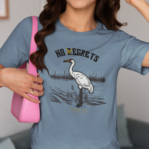 Blue bird shirt featuring a play on the "No Regrets" tattoo that has the "R" crossed out to say "No Egrets" with a Whooping Crane below in a wetland setting. Worn by a woman.