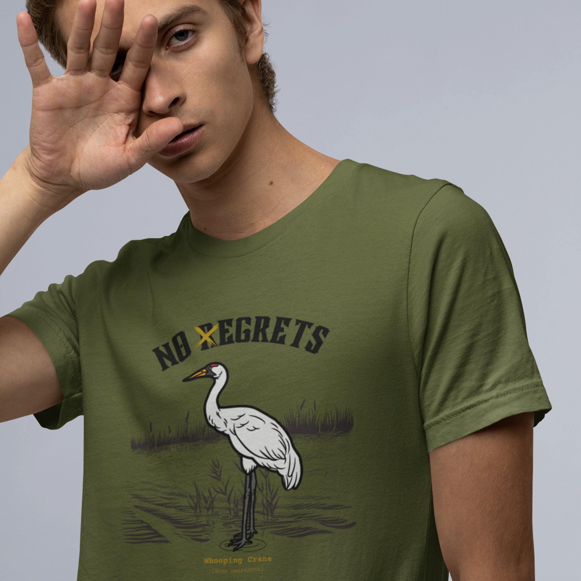 Off white bird shirt featuring a play on the "No Regrets" tattoo that has the "R" crossed out to say "No Egrets" with a Whooping Crane below in a wetland setting.