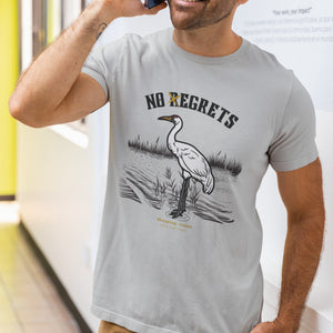 Off white bird shirt featuring a play on the "No Regrets" tattoo that has the "R" crossed out to say "No Egrets" with a Whooping Crane below in a wetland setting. Worn by a man.