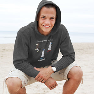 Heather gray birder hoodie with a red-footed, blue-footed and brown booby on it, but referencing only the scientific family name for the bird. Worn by a man on a beach.