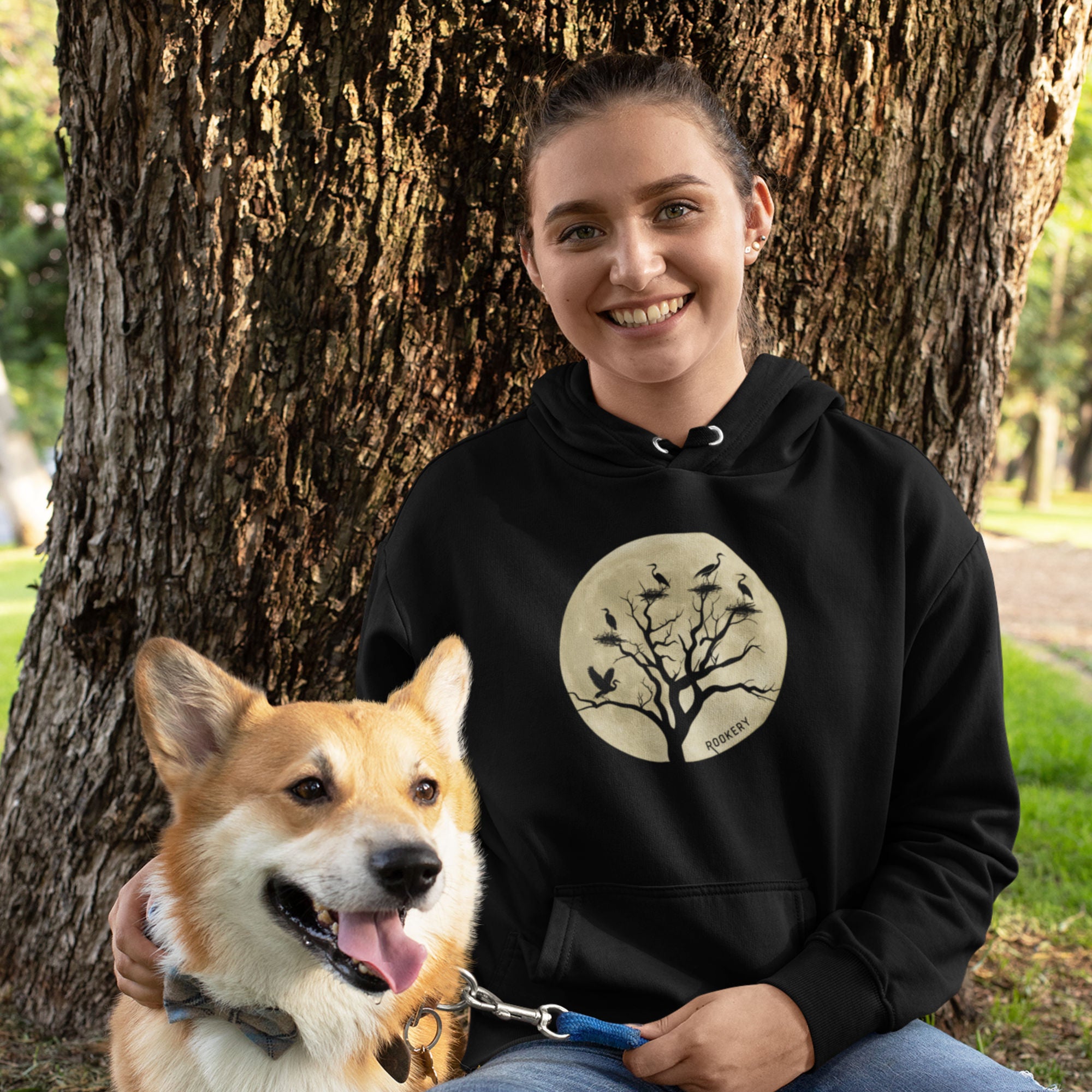 Black bird hoodie with a full moon outlining a heron rookery.  Worn by a woman.