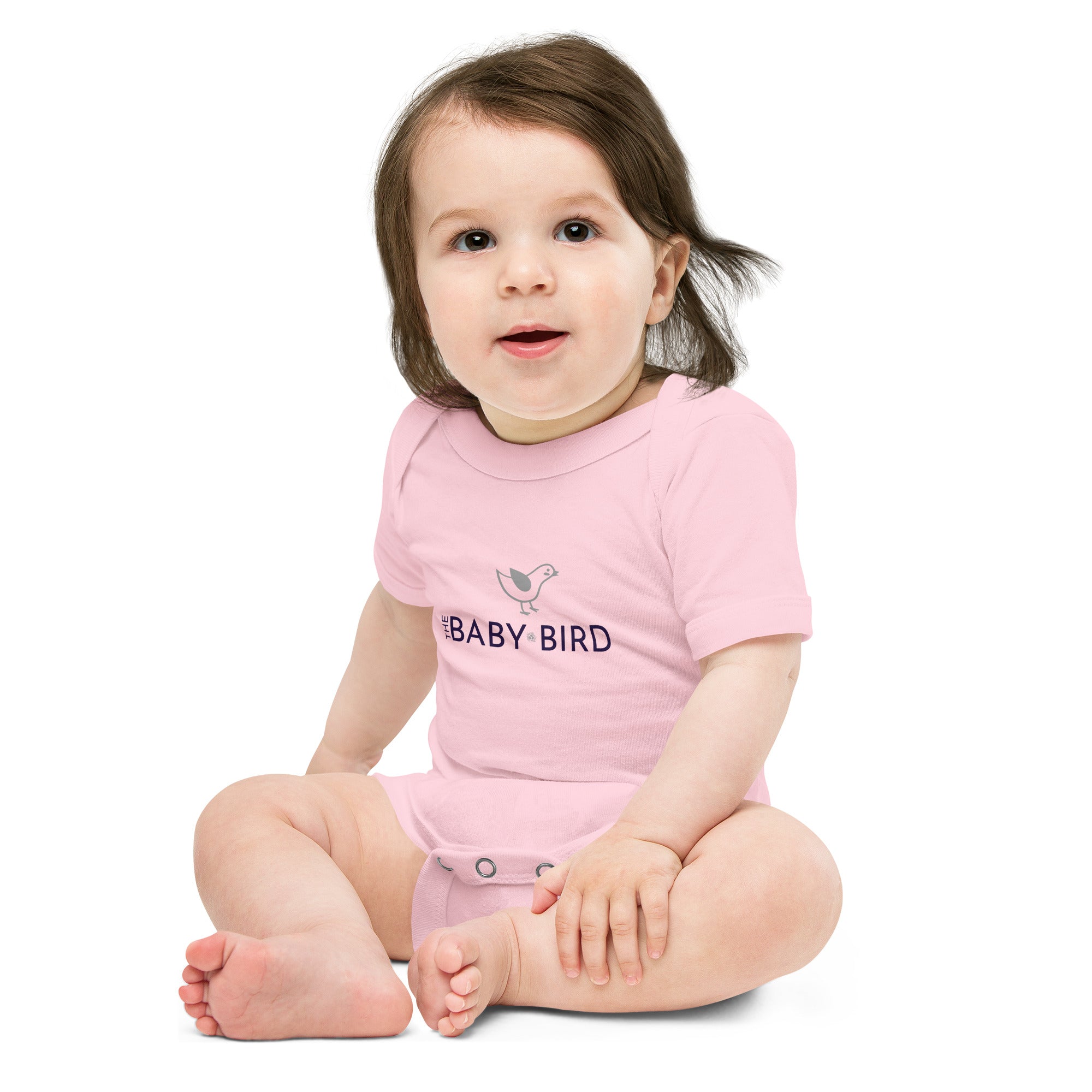 White baby bodysuit with a graphic of a bird and the words The Baby Bird beneath.