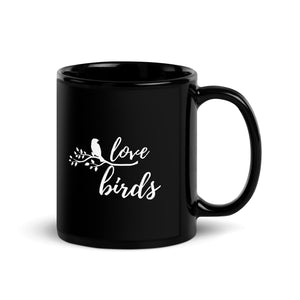 Black 11-ounce mug with the words Love birds and a graphic of a bird on a branch in white.