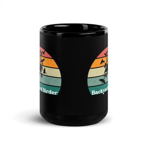 Black bird mug with a retro sun design outlining a bird feeder with the words Backyard Birder.