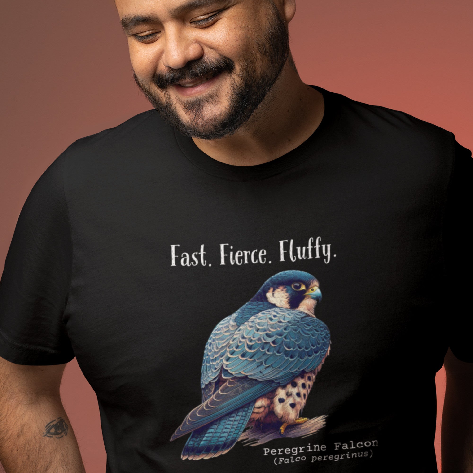 A black bird shirt with the words, "Fast. Fierce. Fluffy" above an illustration of a peregrine falcon.