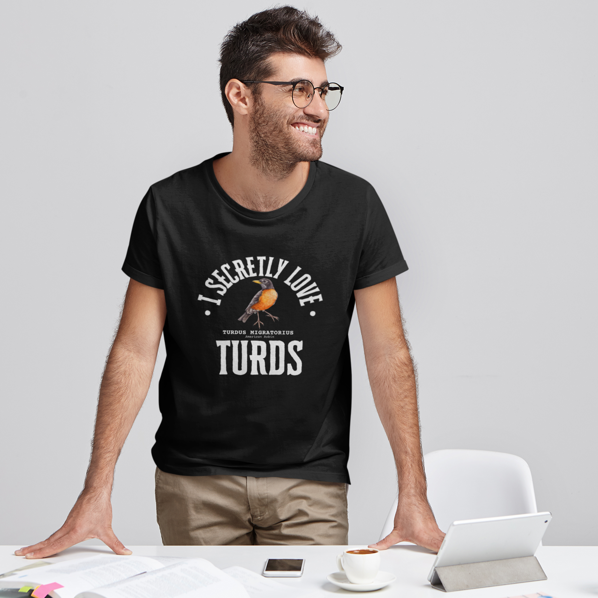 Navy blue bird t-shirt with the words, "I Secretly Love Turds" on the front surrounding an illustration of an American Robin with its common and scientific names.