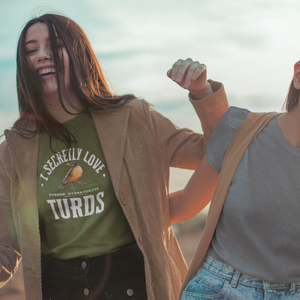 Olive green bird t-shirt with the words, "I Secretly Love Turds" on the front surrounding an illustration of an American Robin with its common and scientific names. Worn by a woman.