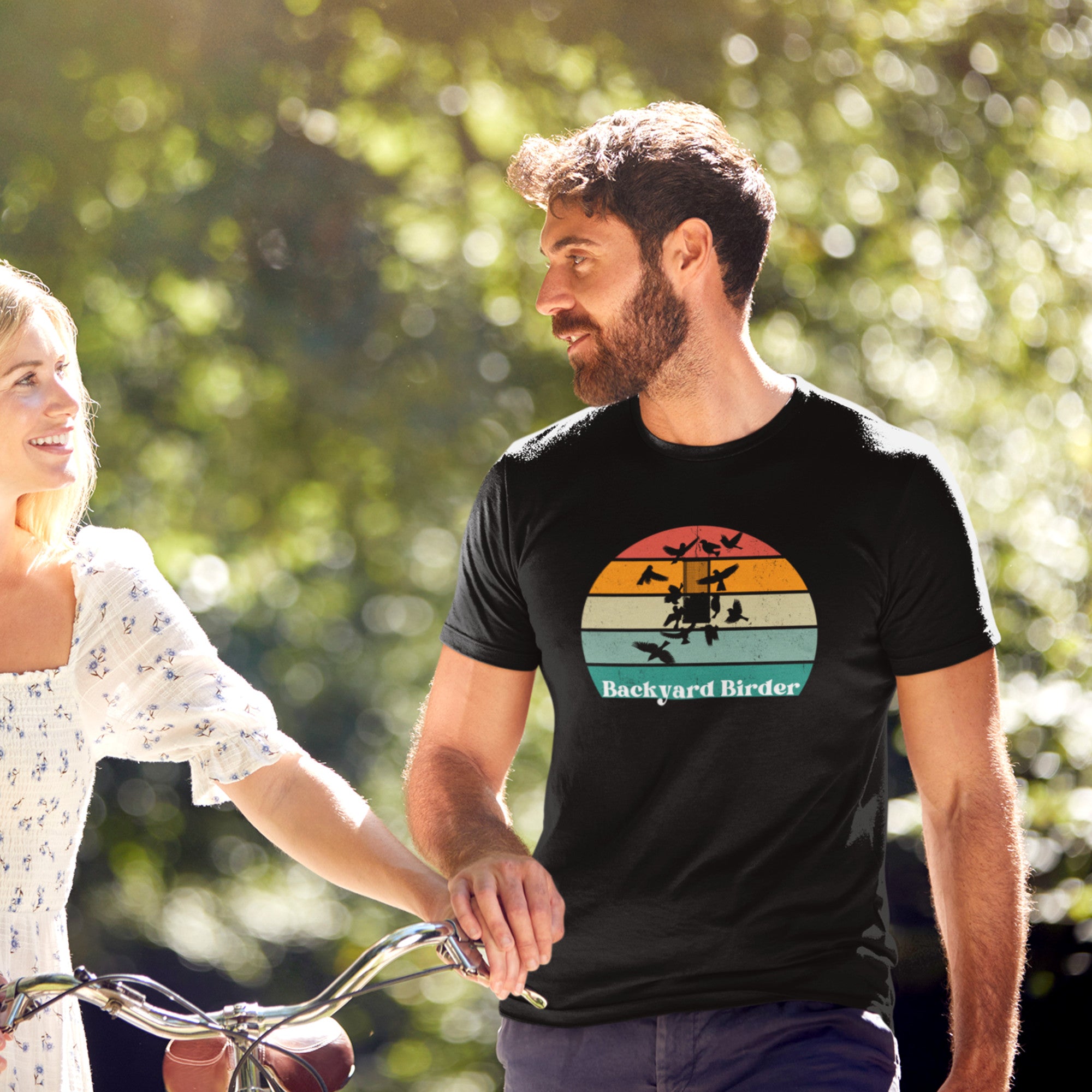 Navy blue bird shirt with a retro sun design outlining a bird feeder with the words Backyard Birder.