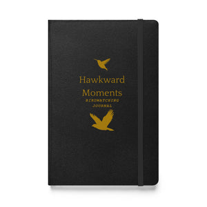 Hardcover bound birding notebook in black with the words, "Hawkward Moments, Birdwatching Journal" on the front with silhouettes of birds above and below.