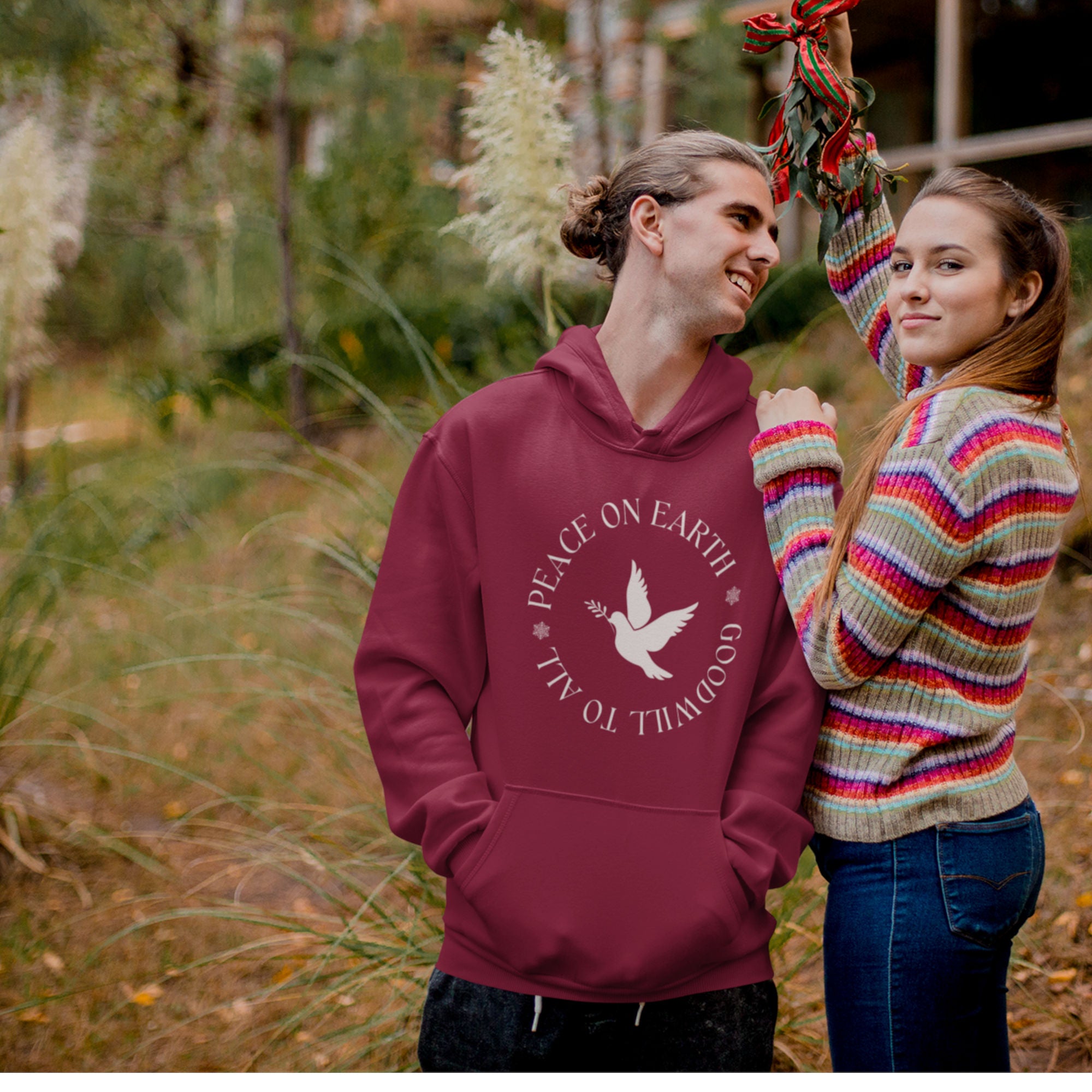 Maroon unisex hoodie that says Peace on Earth Goodwill to All in a circle surrounding a dove of peace.