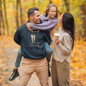 Navy blue unisex birding hoodie that has silhouettes of a man and a woman using binoculars overlayed on a stack of the word Birds with the saying, "Never Stop Birding" at the bottom and colorful silhouette of different birds at the top. Worn by a man giving a piggy-back ride to a child.