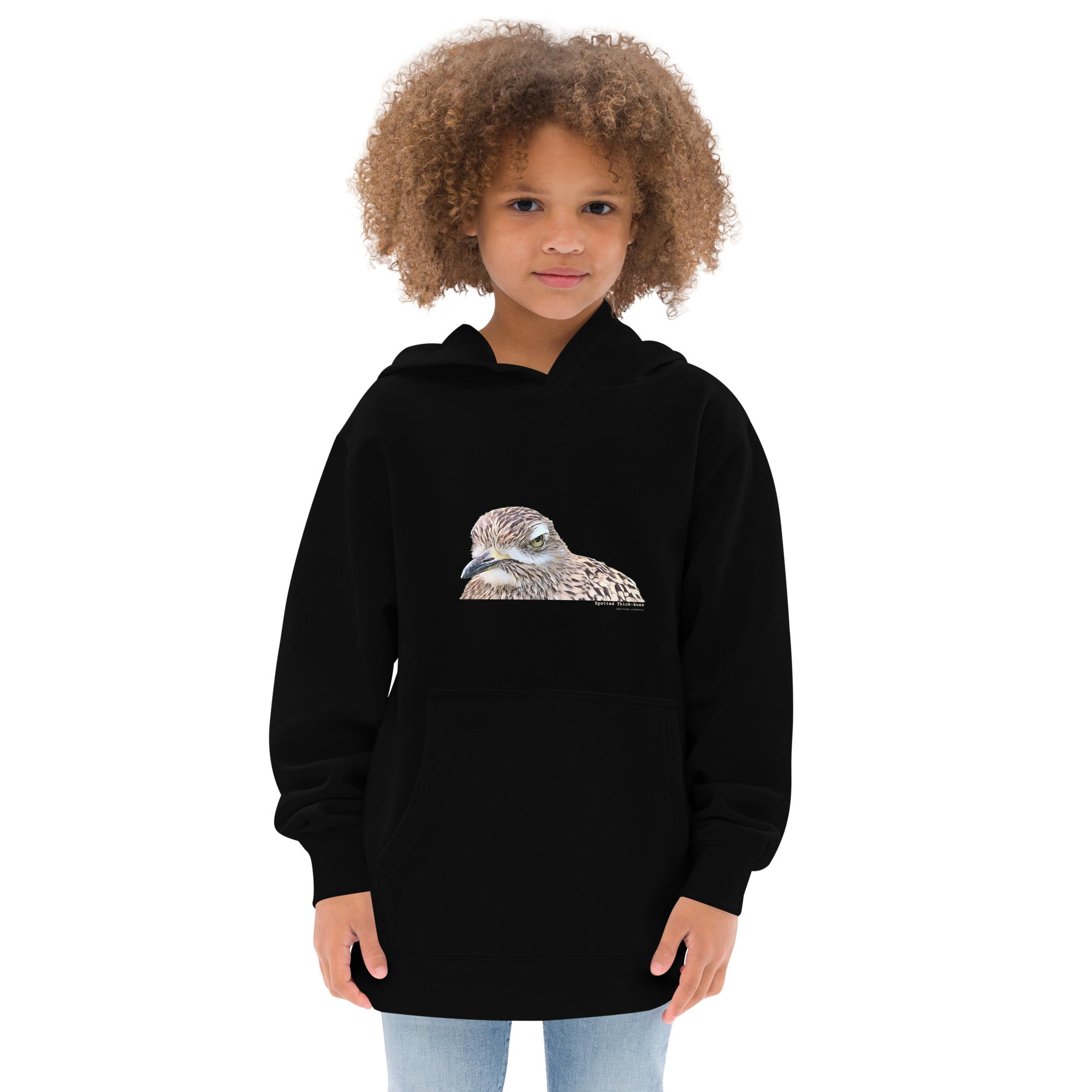 Black unisex youth bird hoodie with an illustrated picture of a spotted thick-knee bird looking grumpy. The words spotted thick-knee are written below the illustration, including the scientific name..