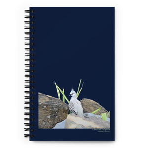 Spiral Notebook with an illustrated picture crested pigeon bird amongst some grass and rocks, on a dark blue background. The words Crested Pigeon are written below the picture and the scientific name below that..