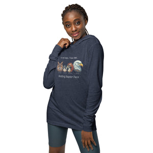 Navy heather, long-sleeve, hooded bird t-shirt with a group of raptors and a funny saying about resting raptor faces. Worn by a woman.