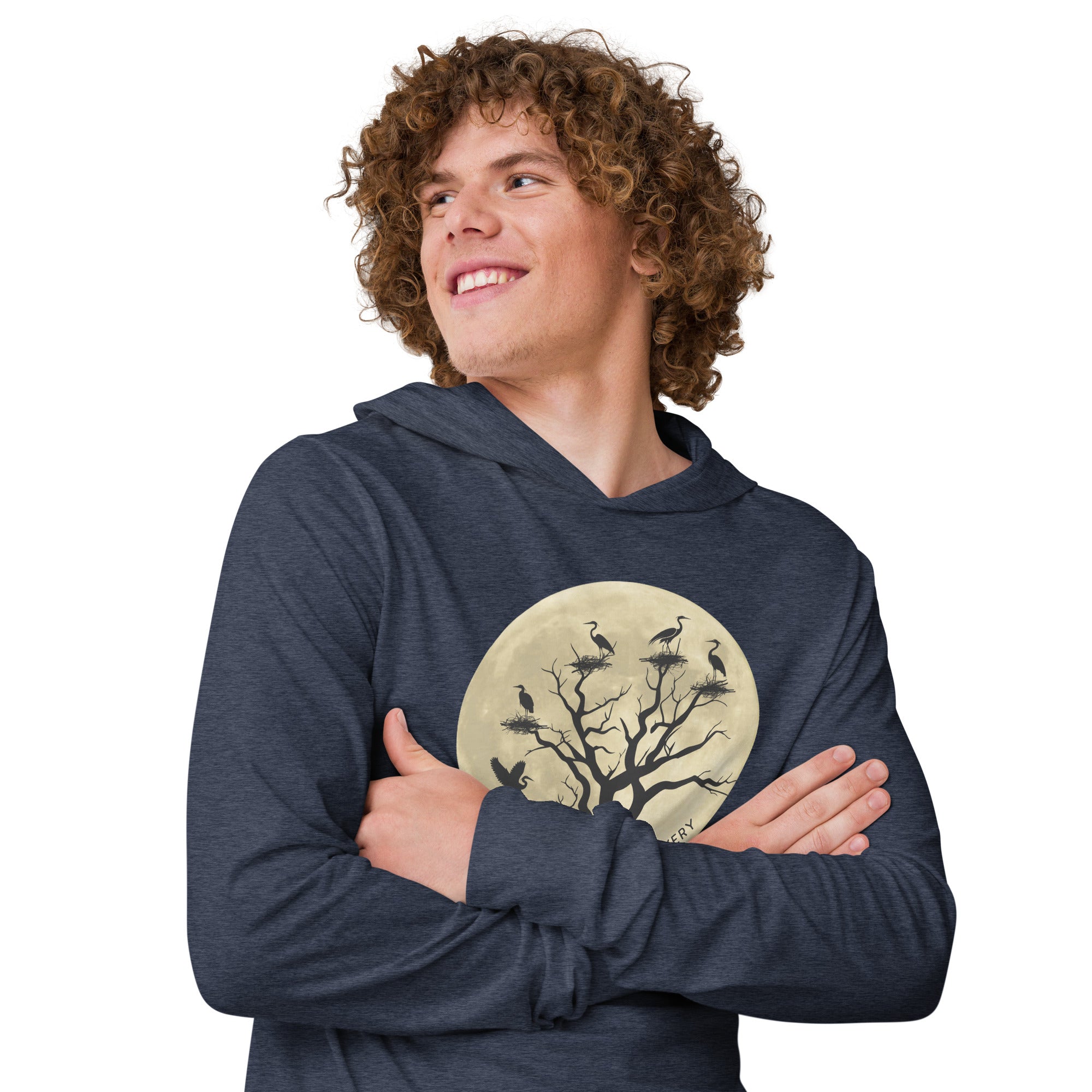 Navy heather, long-sleeve, hooded bird t-shirt with a full moon outlining a heron rookery. Worn by a man.