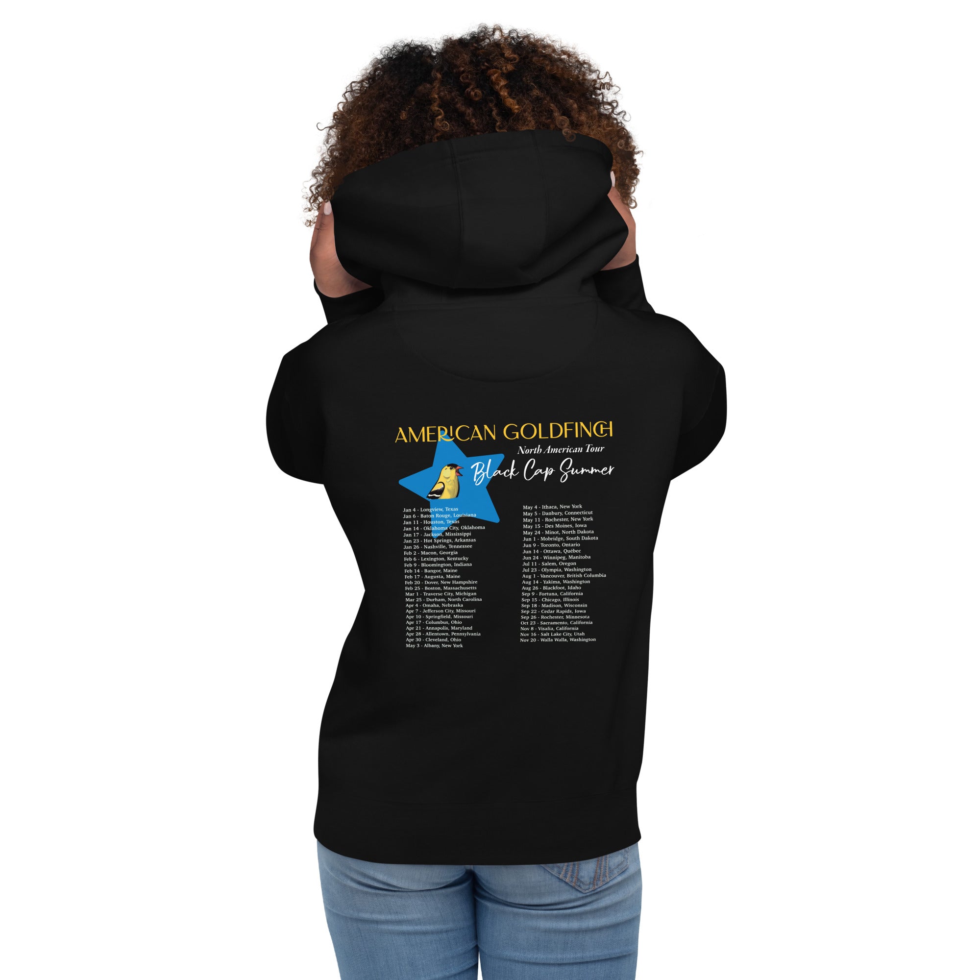 Black unisex bird hoodie featuring an American goldfinch singing into a microphone with a list of dates and cities on the back where the american goldfinch is commonly seen. Rear view of bird hoodie shown.