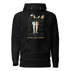 Black unisex birding hoodie that has silhouettes of a man and a woman using binoculars overlayed on a stack of the word Birds with the saying, "Never Stop Birding" at the bottom and colorful silhouette of different birds at the top.