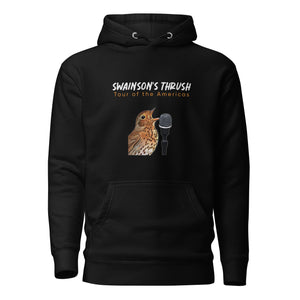 Black unisex bird hoodie mimicking a concert hoodie with the words "Swainson's Thrush" and below that, "Tour of the Americas" and below that an illustrated Swainson's thrush singing into a microphone. Back of hoodie, (not shown) has "concert dates" and cities where this bird can be heard.