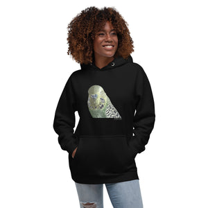 Black unisex bird hoodie with an illustrated and lifelike graphic of a green and yellow parakeet or budgie on the front. Below and to the right of the picture is the word Budgerigar and below that the scientific name in parenthesis in small print. Worn by a woman.