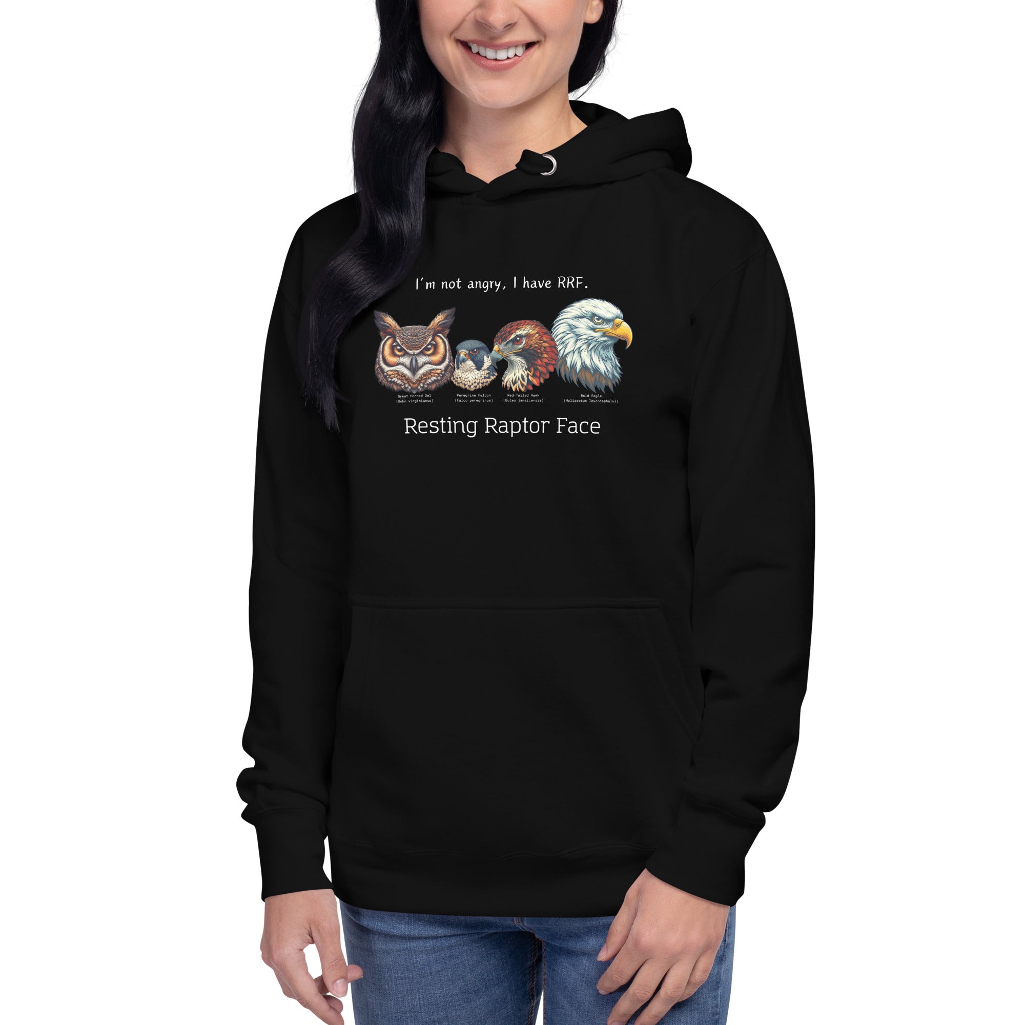 A black bird hoodie with a great horned owl, a peregrine falcon, a red-tailed hawk and a bald eagle. The shirt has text that says, I'm not angry, I have RRF. Resting Raptor Face. Worn by a woman.