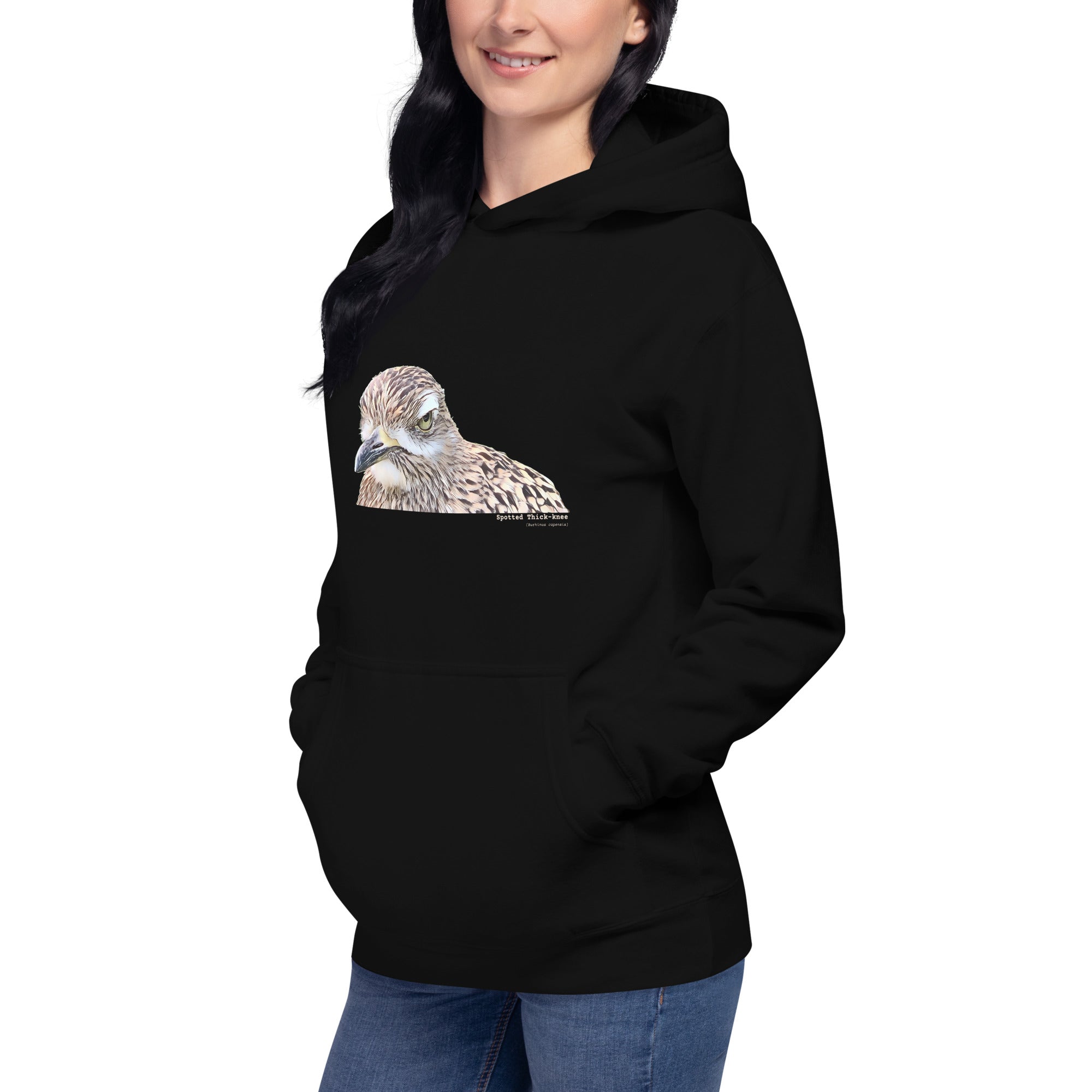 Black unisex bird hoodie with an illustrated picture of a spotted thick-knee bird looking grumpy. The words spotted thick-knee are written below the illustration, including the scientific name.