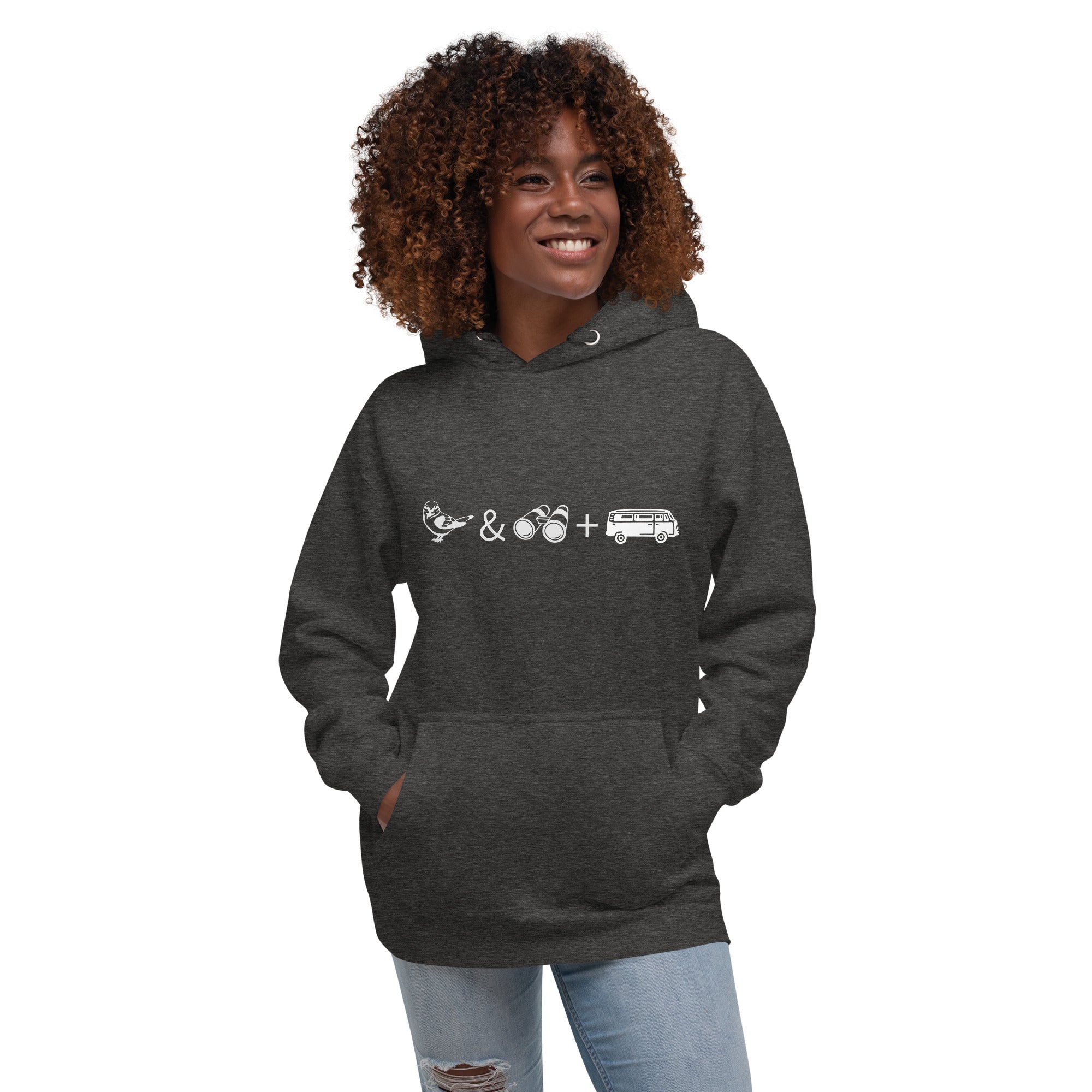 Dark heather grey unisex birding hoodie with graphics of binoculars, birds and a van. Worn by a woman.