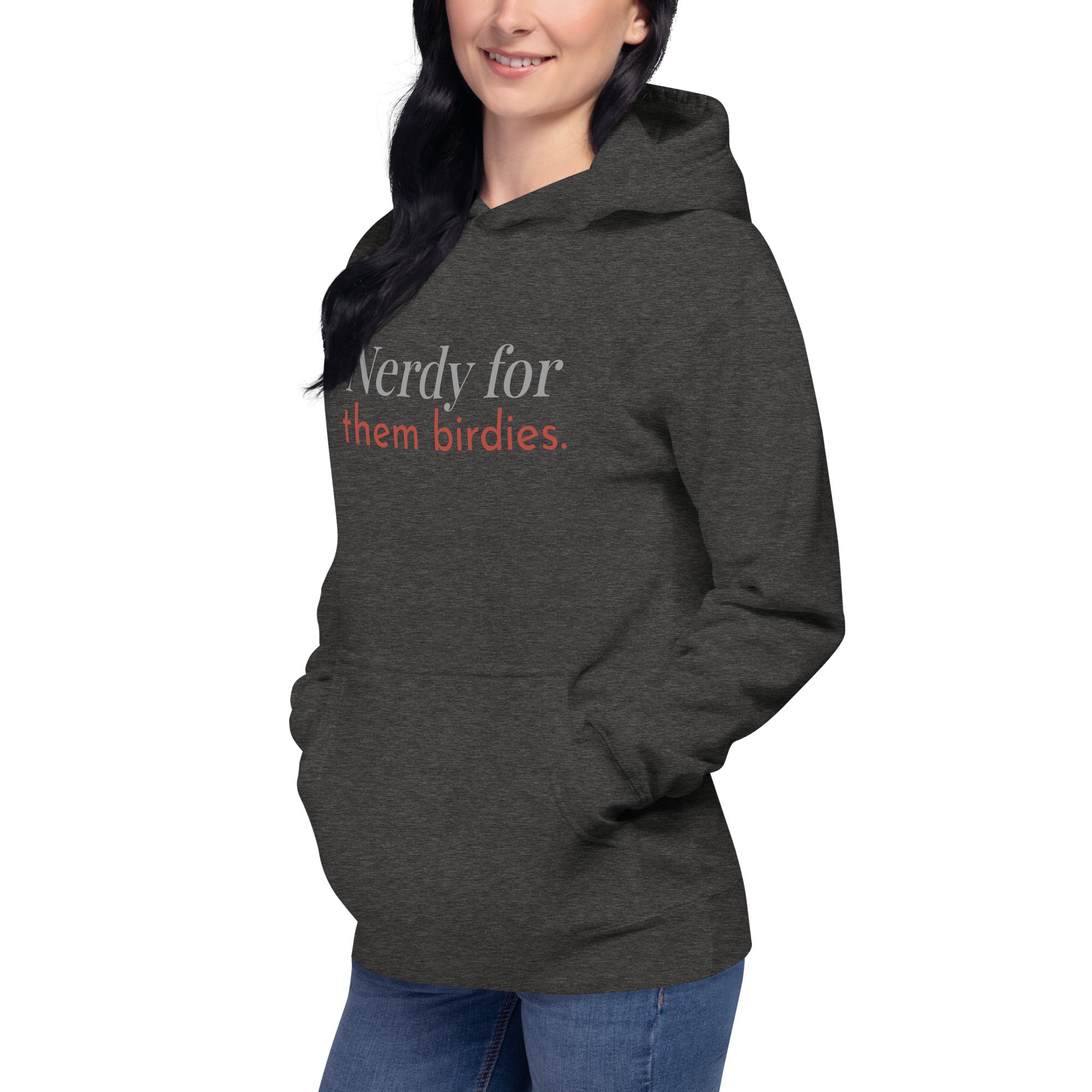 Dark heather gray unisex bird hoodie with the words Nerdy for them birdies on the front in two coordinating fonts and colors. Worn by a woman.