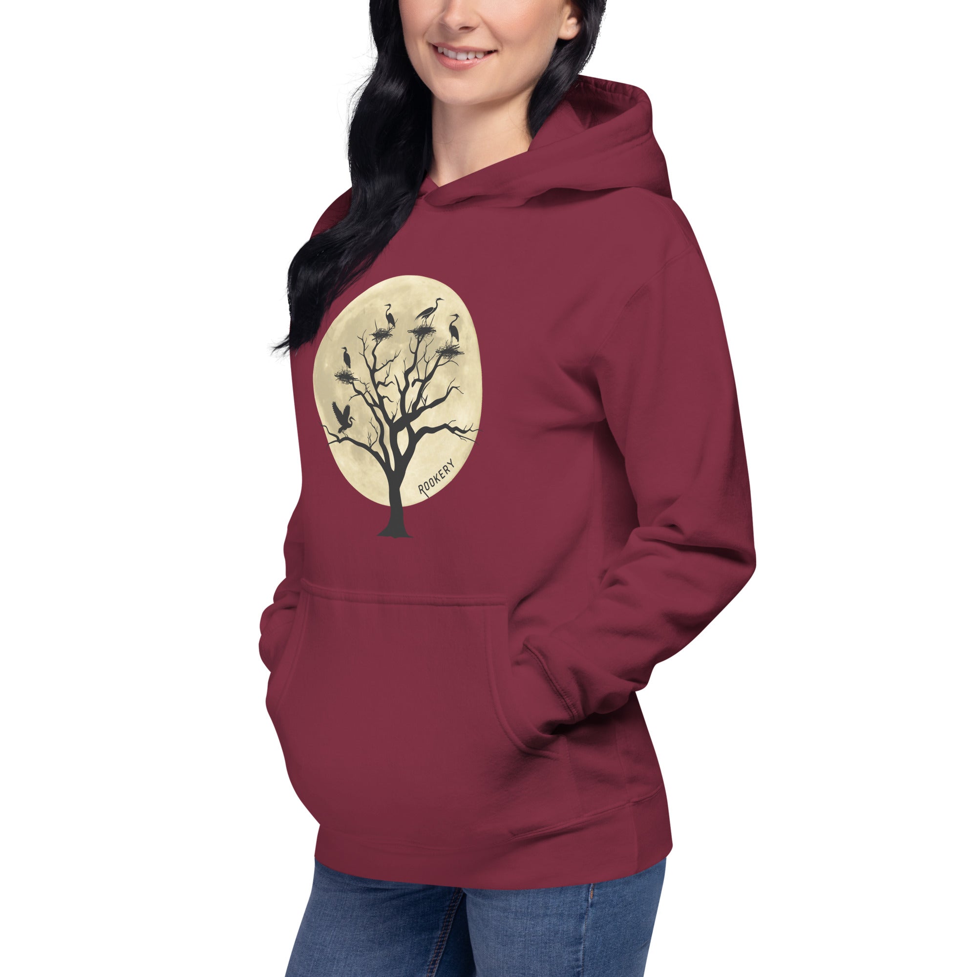 Maroon bird hoodie with a full moon outlining a heron rookery.  Worn by a woman.