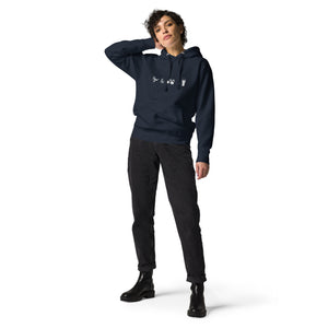 Unisex navy blue hooded bird sweatshirt celebrating bird watching and beer with a graphic of binoculars, a bird, and a glass of beer. Worn by a woman.