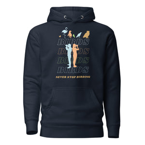 Navy blue unisex birding hoodie that has silhouettes of a man and a woman using binoculars overlayed on a stack of the word Birds with the saying, "Never Stop Birding" at the bottom and colorful silhouette of different birds at the top.