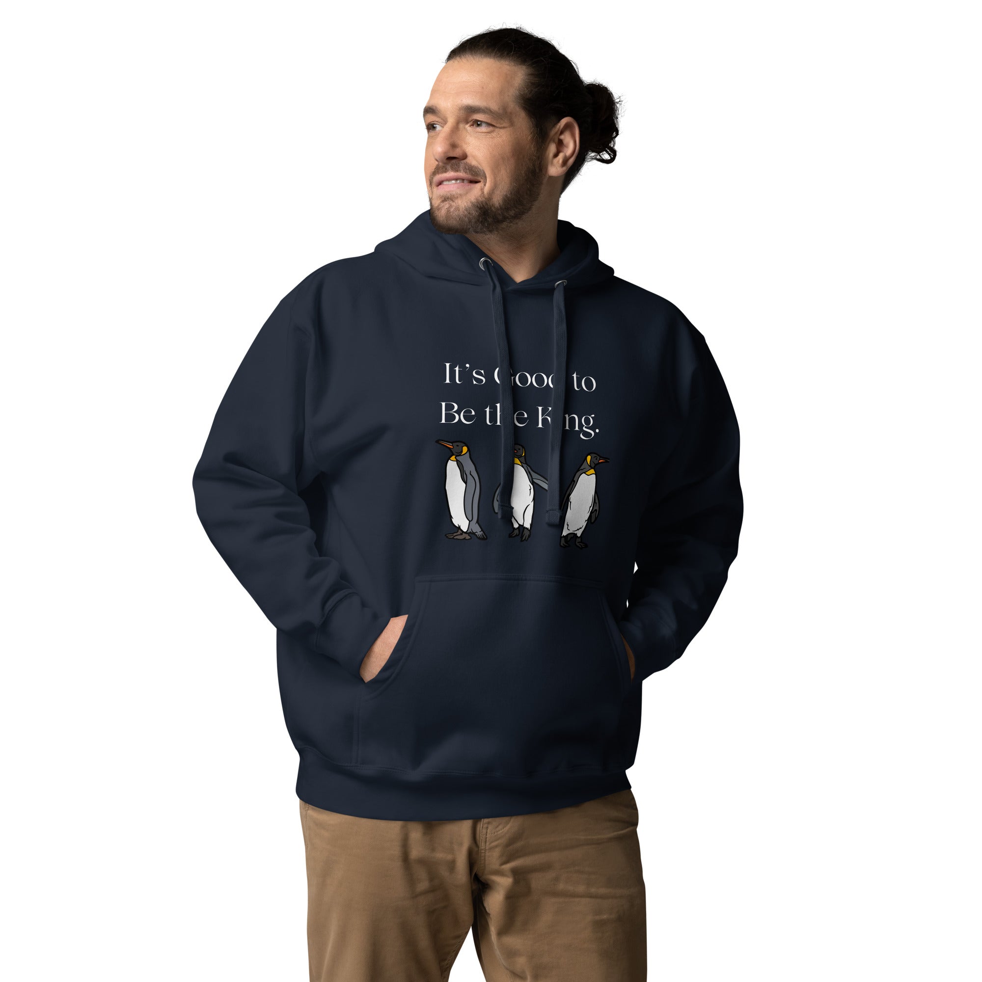 Navy blue unisex bird hoodie with three king penguins below the phrase, "It's Good to Be The King." Worn by a man.