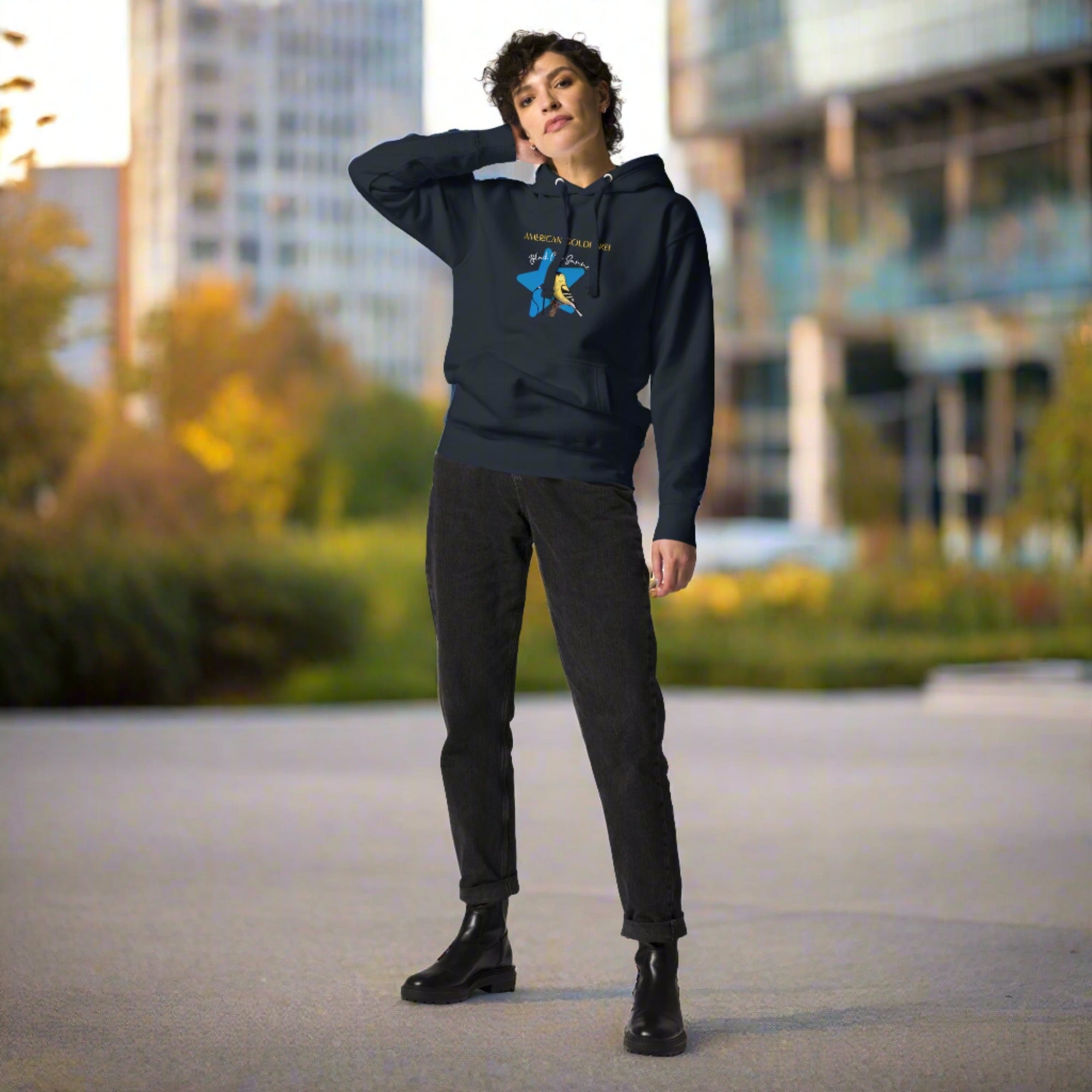 Navy blue unisex bird hoodie featuring an American goldfinch singing into a microphone with a list of dates and cities on the back where the american goldfinch is commonly seen.