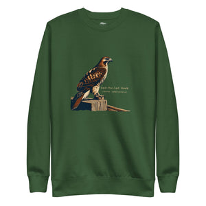 Green birding sweatshirt with an artistic depiction of a red-tailed hawk sitting on a fence and the common and scientific names for the bird next to it.