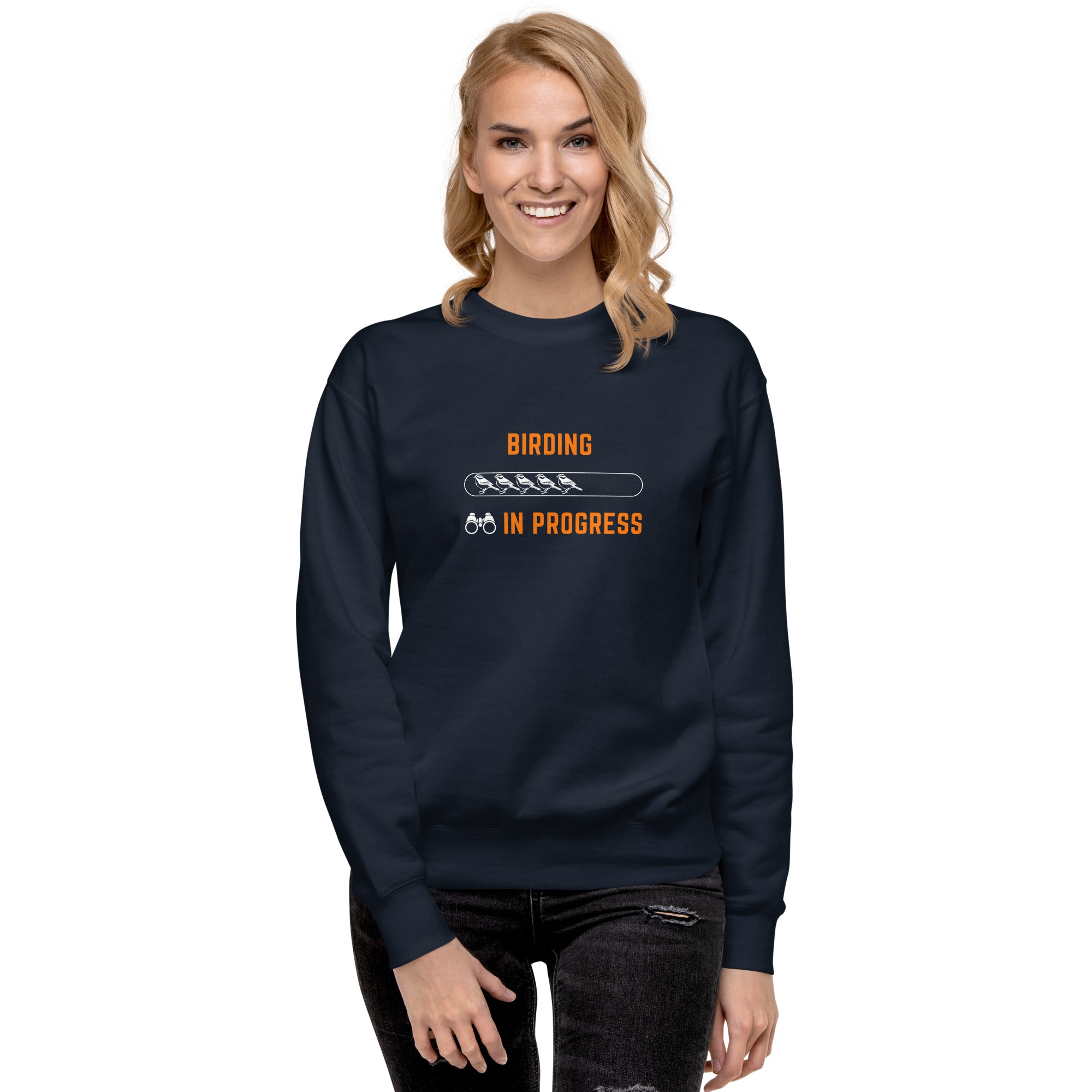 Navy birding sweatshirt with the words Birding in Progress on the front around a loading progress bar. Worn by a woman.