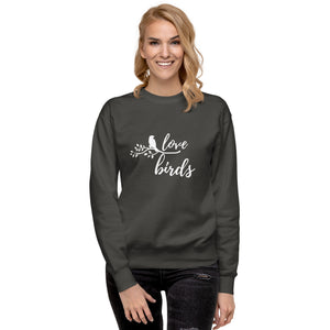 Vintage black birding sweatshirt with the words Love birds and a graphic of a bird on a branch in white. Worn by a woman.