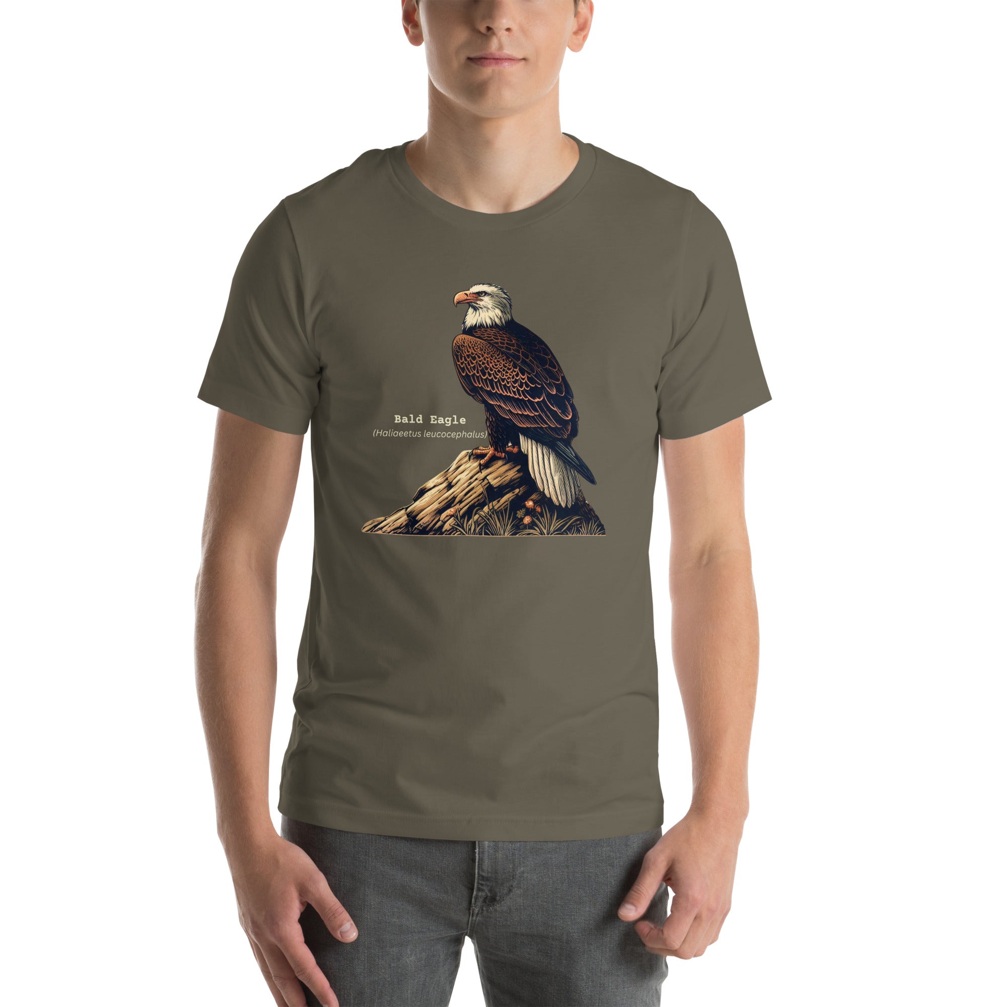 Army green bird shirt with an artistic depiction of aBald Eagle sitting on a rock and the birds common and scientific names next to the bird. Worn by a man.