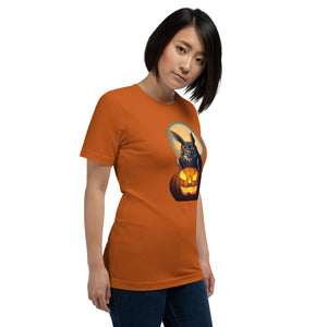 Orange bird t-shirt with a great horned owl sitting behind a jack-o-lantern with a full moon rising behind. Worn by a woman.