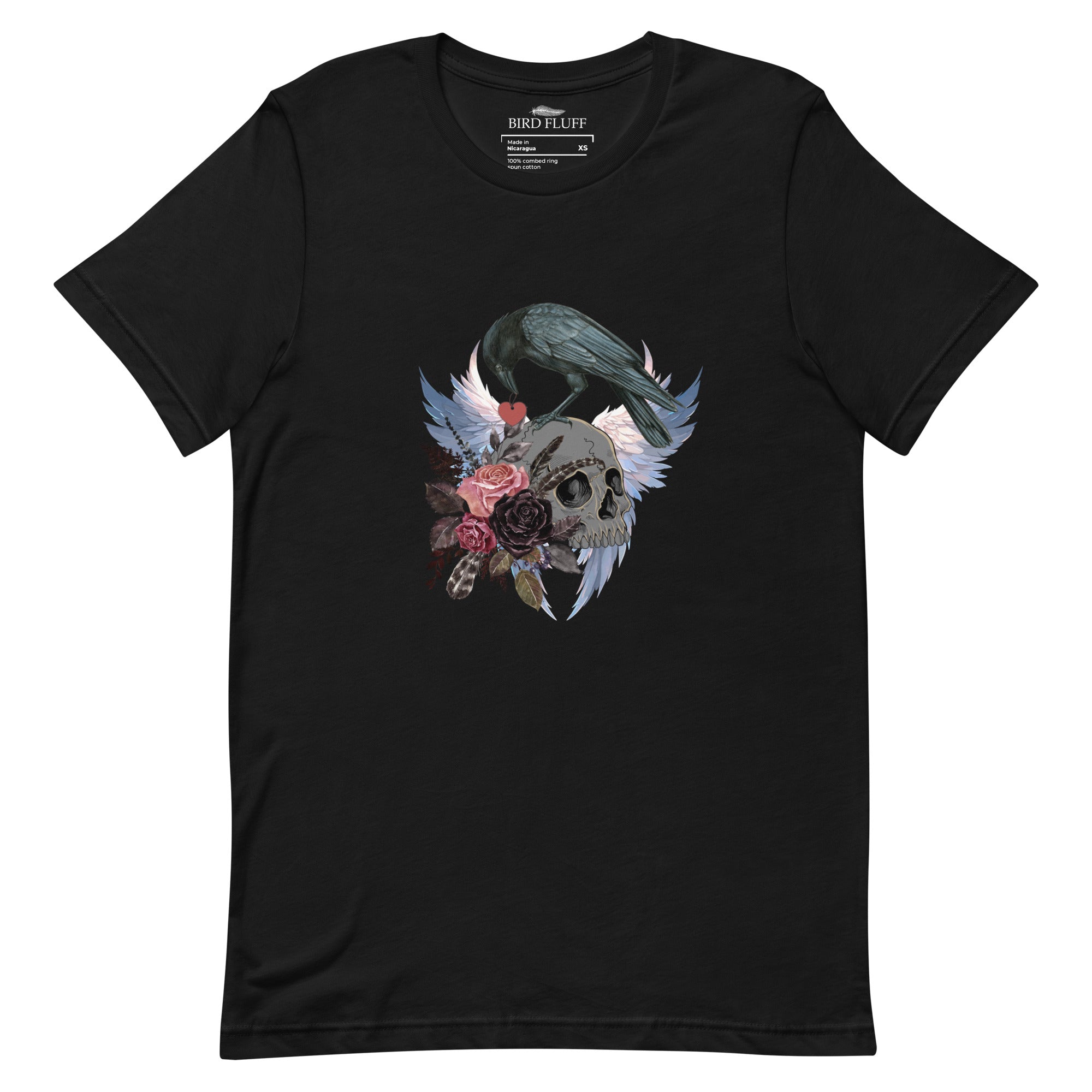 Gothic themed black bird shirt with a crow carrying a heart pendant, perched on a skull surrounded by flowers, feathers and wings.