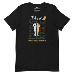 Black unisex birding t-shirt that has silhouettes of a man and a woman using binoculars overlayed on a stack of the word Birds with the saying, "Never Stop Birding" at the bottom and colorful silhouette of different birds at the top.