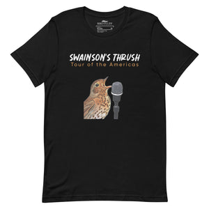 Black unisex bird shirt mimicking a concert t-shirt with the words "Swainson's Thrush" and below that, "Tour of the Americas" and below that an illustrated Swainson's thrush singing into a microphone. Back of shirt, (not shown) has concert dates and cities where this bird can be heard.