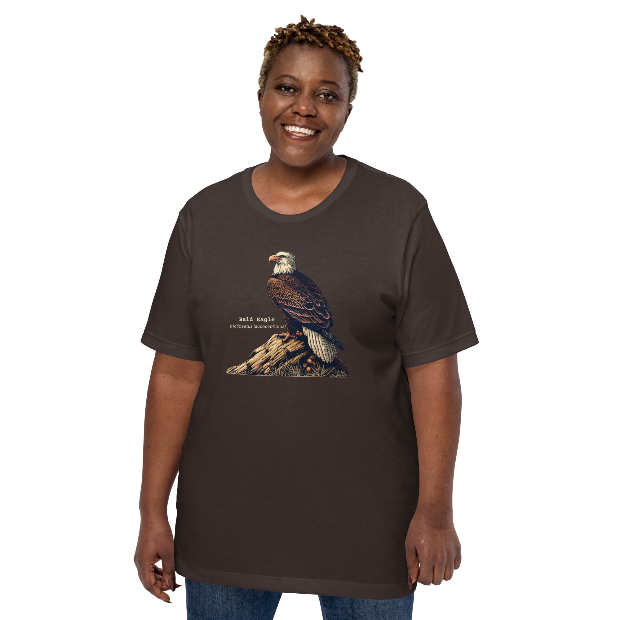 Army green bird shirt with an artistic depiction of aBald Eagle sitting on a rock and the birds common and scientific names next to the bird.