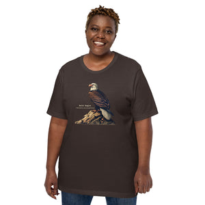 Brown bird shirt with an artistic depiction of aBald Eagle sitting on a rock and the birds common and scientific names next to the bird. Worn by a woman.