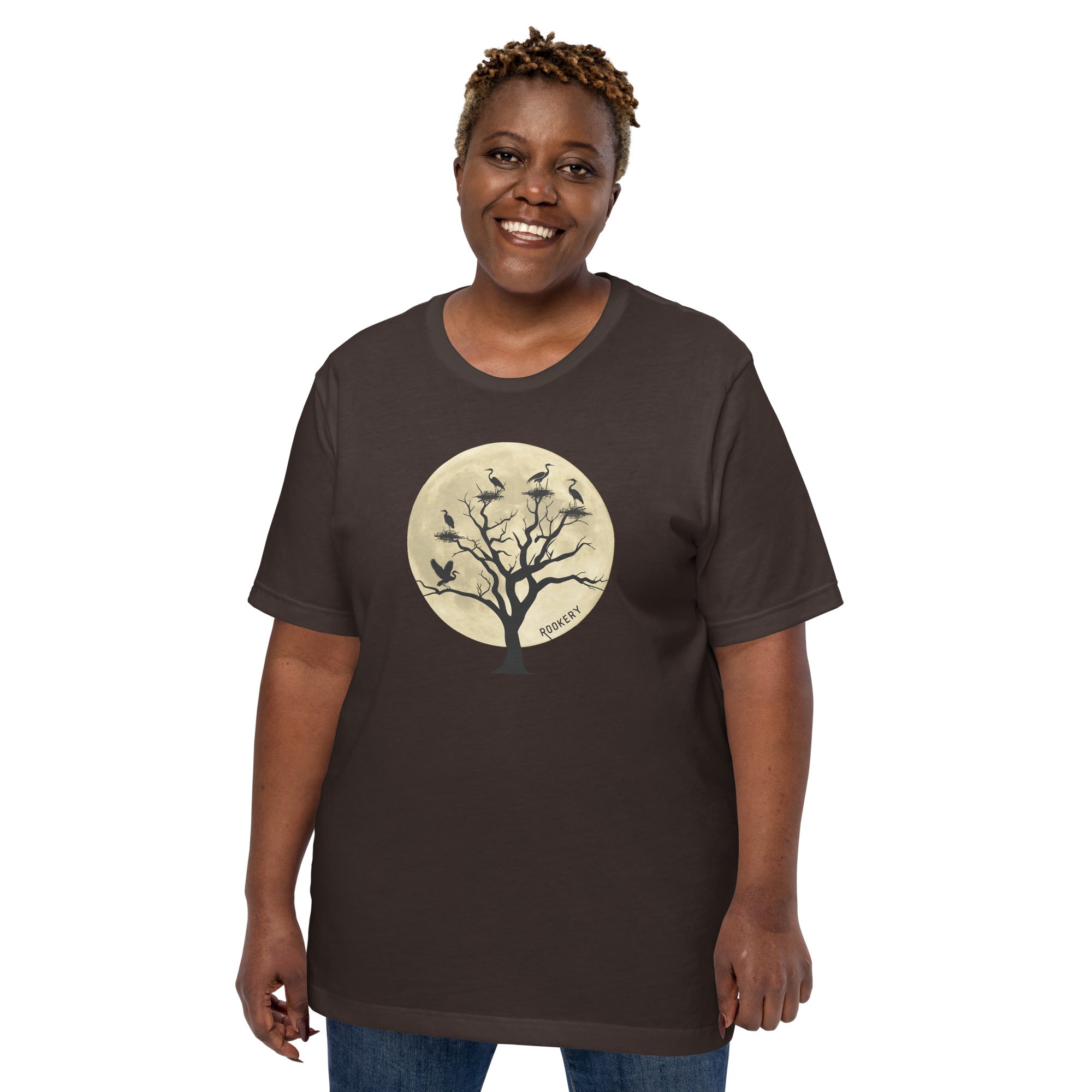 Brown unisex bird shirt with a full moon outlining a heron rookery.  Worn by a woman.