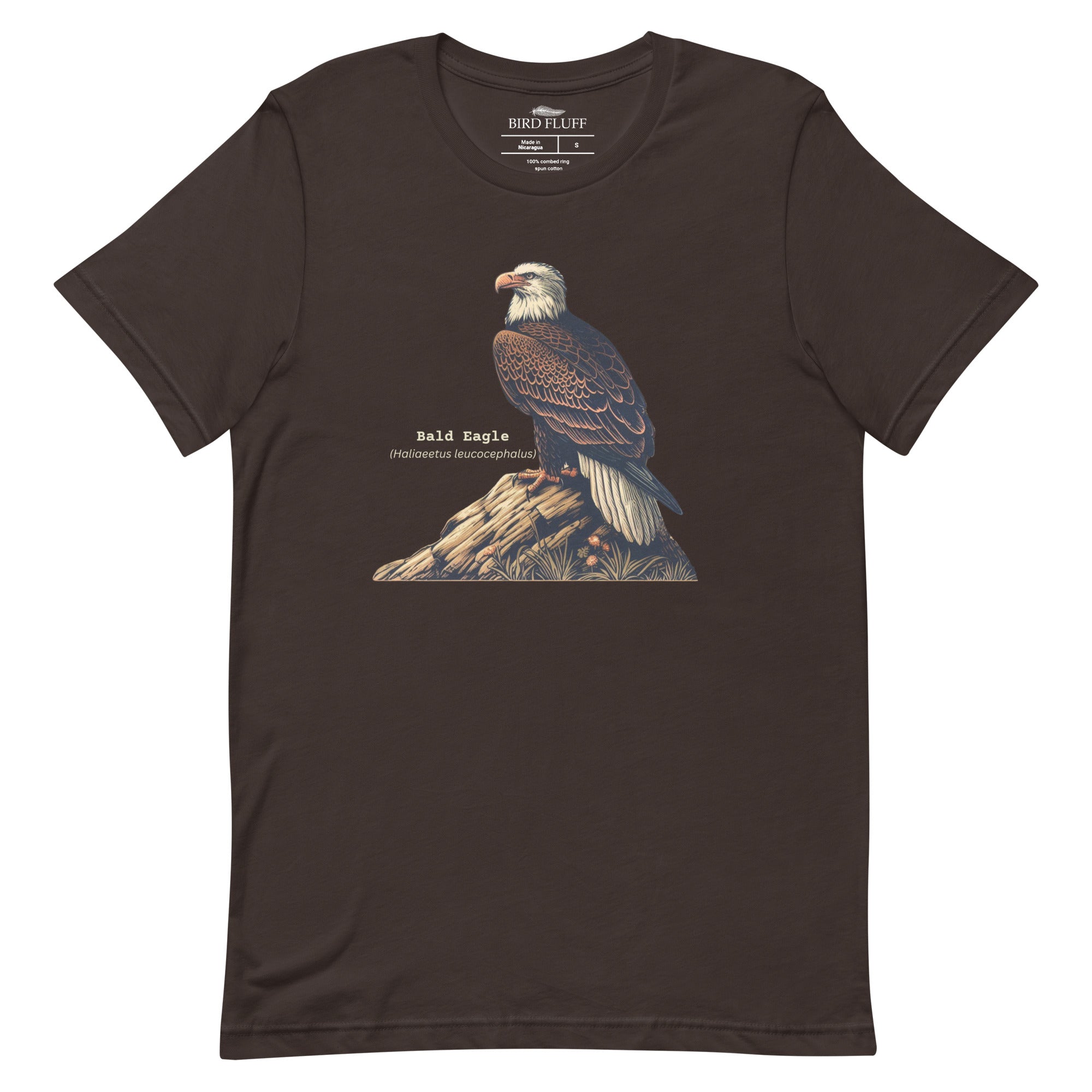 Brown unisex bird shirt with a Bald Eagle perches on a rock, next to its common and scientific names.