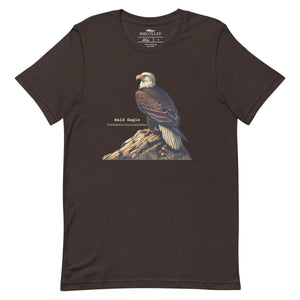 Brown unisex bird shirt with a Bald Eagle perches on a rock, next to its common and scientific names.